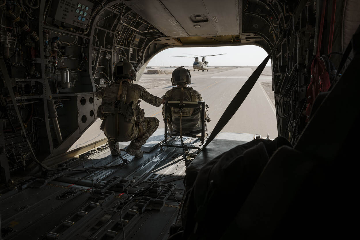 Doorgunners kijken vanuit hun Chinook naar buiten