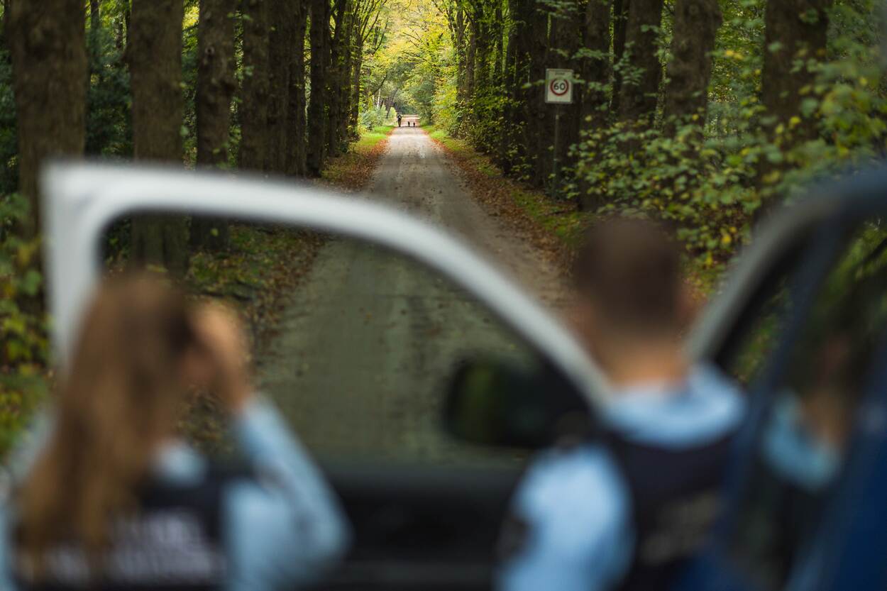 Marechaussees bij voertuig in het bos.