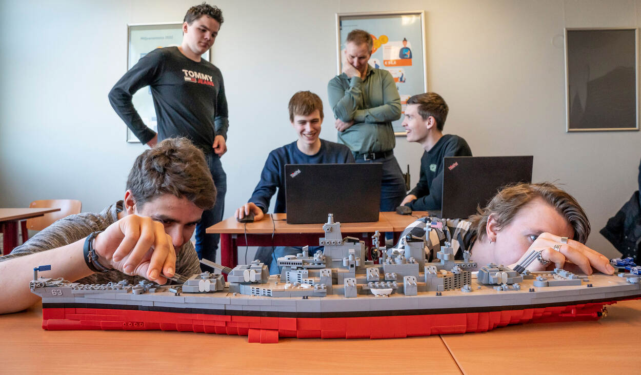 Leerlingen van de Techniekcampus in de Den Helder bouwen aan een Lego-schip.