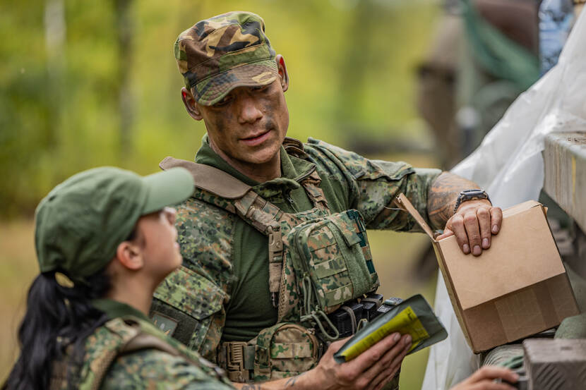 Twee militairen bekijken een gevechtsrantsoen.